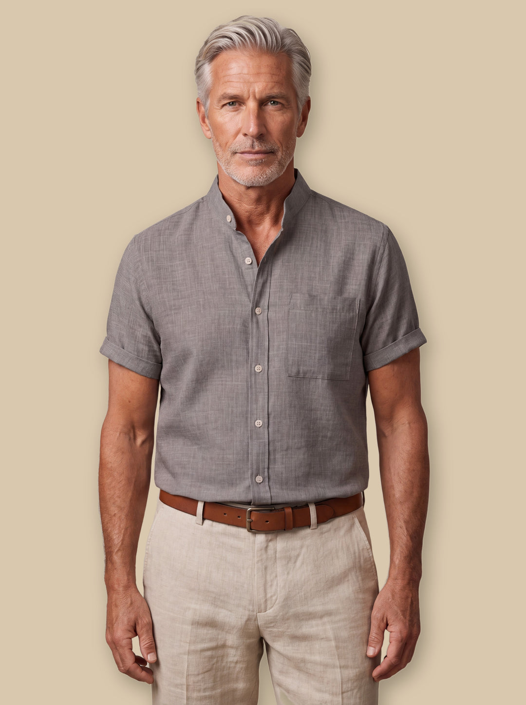 Ambrose linen shirt in Grey, worn by a model on a warm sand studio background - Gentlemens Manor