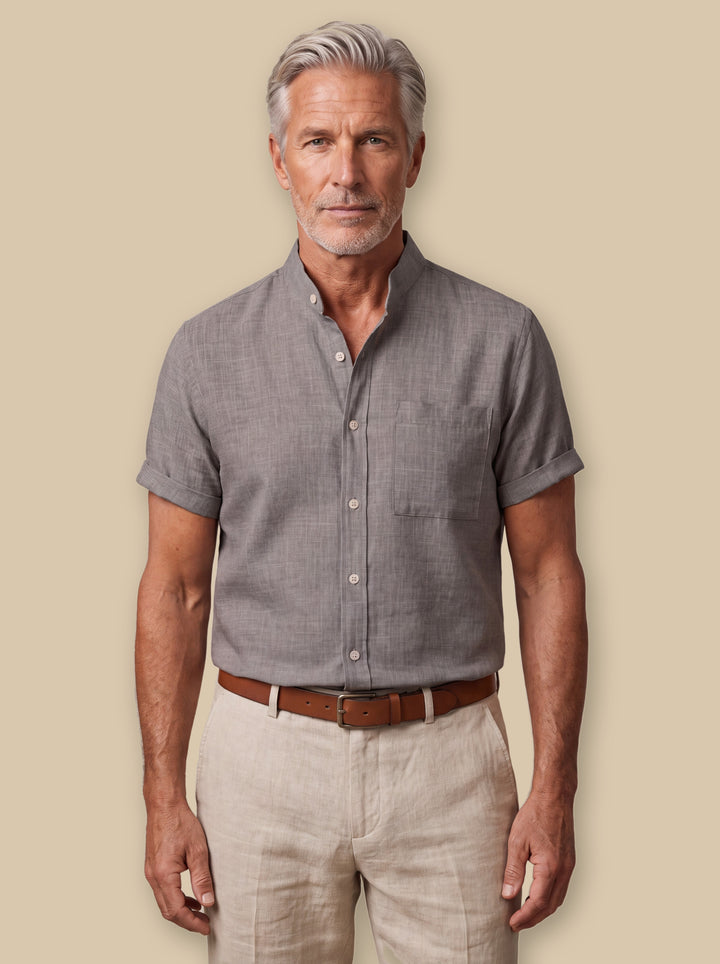 Ambrose linen shirt in Grey, worn by a model on a warm sand studio background - Gentlemens Manor