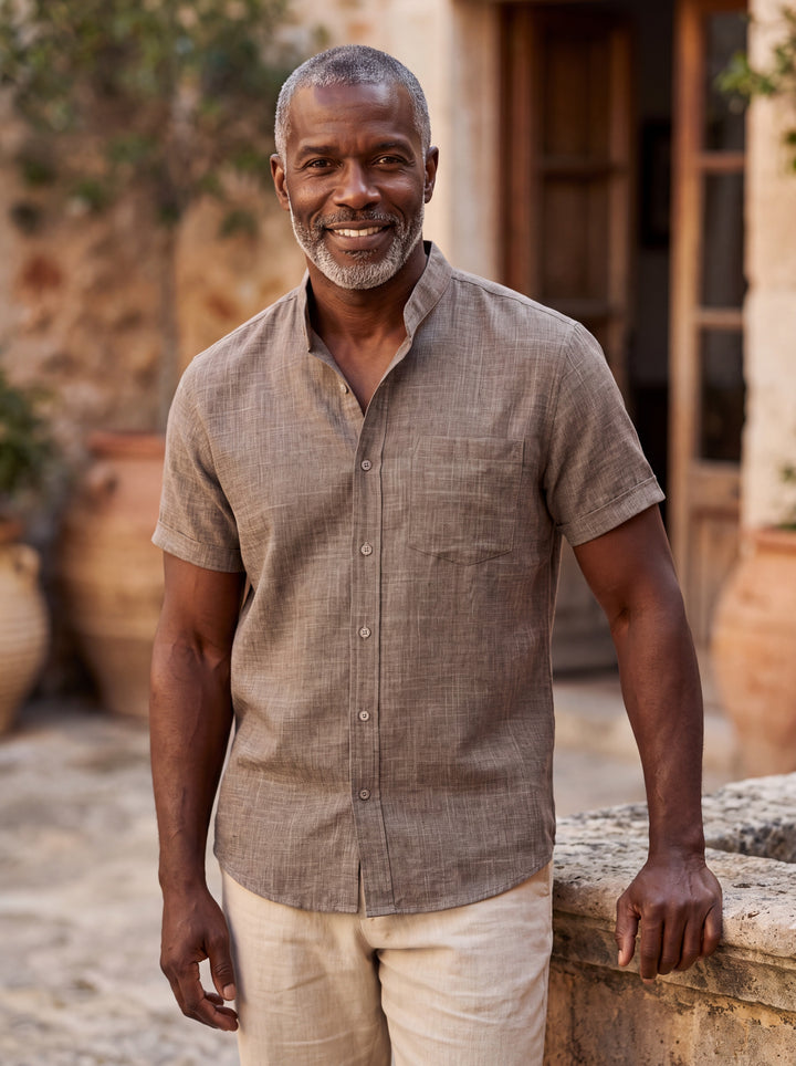 Ambrose Men short sleeve shirt in grey, worn by a model on a Mediterranean terrace - Gentlemens Manor lifestyle