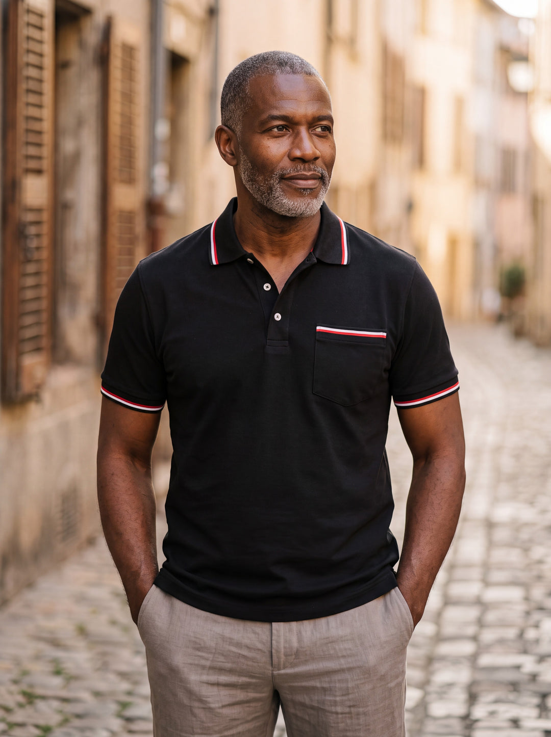Anderson Men polo shirt in black, worn by a model on a Mediterranean terrace - Gentlemens Manor lifestyle