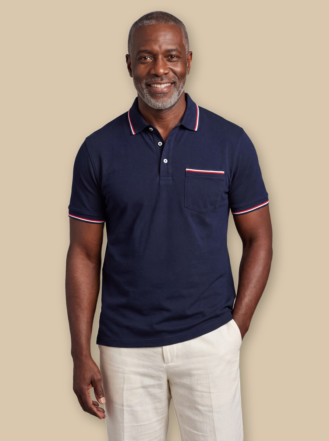 Anderson polo shirt in Navy, worn by a model on a warm sand studio background - Gentlemens Manor
