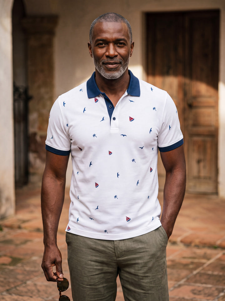 Archibald Men polo shirt in white, worn by a model on a Mediterranean terrace - Gentlemens Manor lifestyle