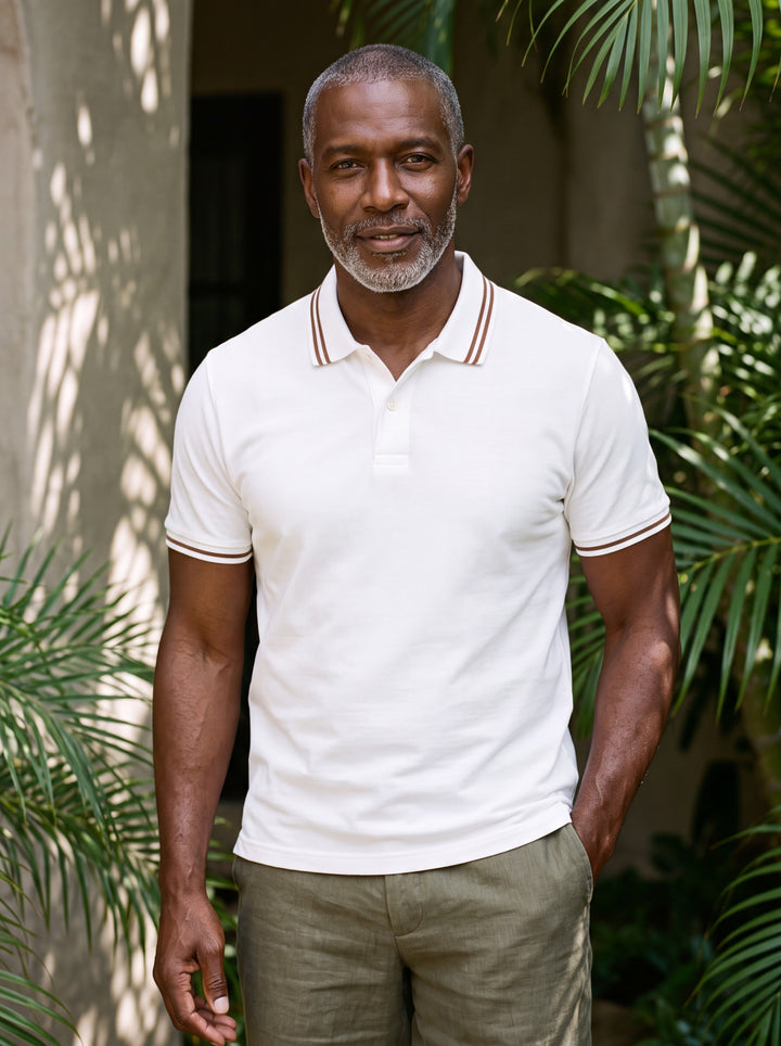 Arnold Men polo shirt in white, worn by a model on a Mediterranean terrace - Gentlemens Manor lifestyle
