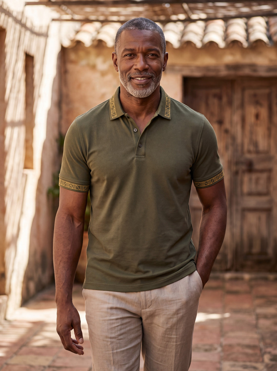 Arthur Men polo shirt in green, worn by a model on a Mediterranean terrace - Gentlemens Manor lifestyle