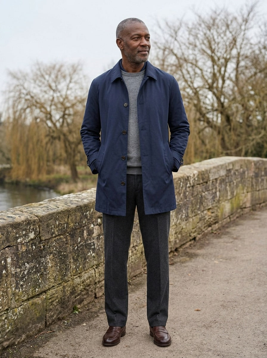 Aubrey single breasted mac coat in Navy, lifestyle on a stone footbridge, Gentlemens Manor