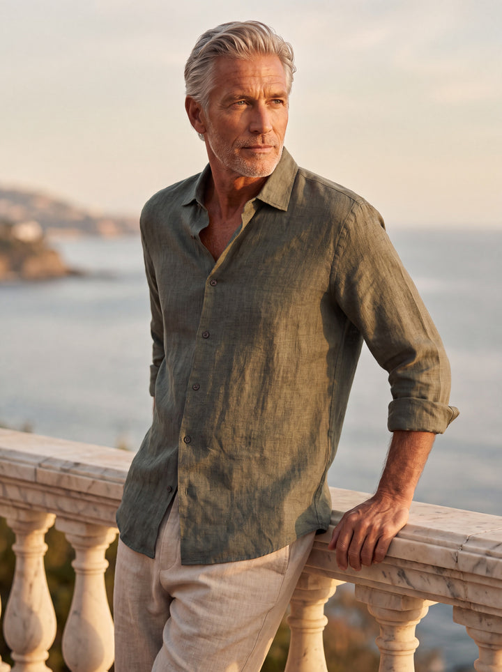 August Men linen shirt in Olive, worn by a model on a Mediterranean terrace - Gentlemens Manor lifestyle