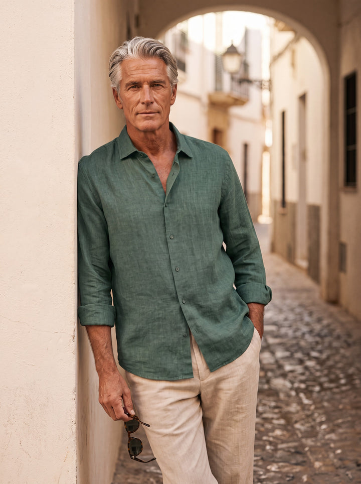 August Men linen shirt in green, worn by a model on a Mediterranean terrace - Gentlemens Manor lifestyle