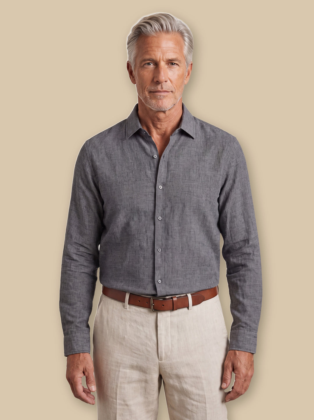 August linen shirt in Grey, worn by a model on a warm sand studio background - Gentlemens Manor