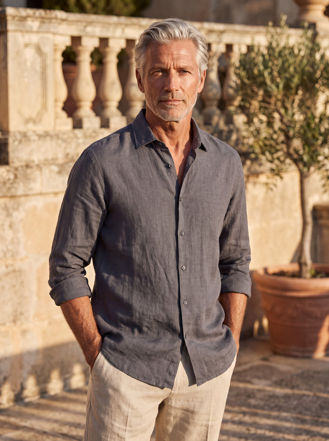 August Men linen shirt in grey, worn by a model on a Mediterranean terrace - Gentlemens Manor lifestyle
