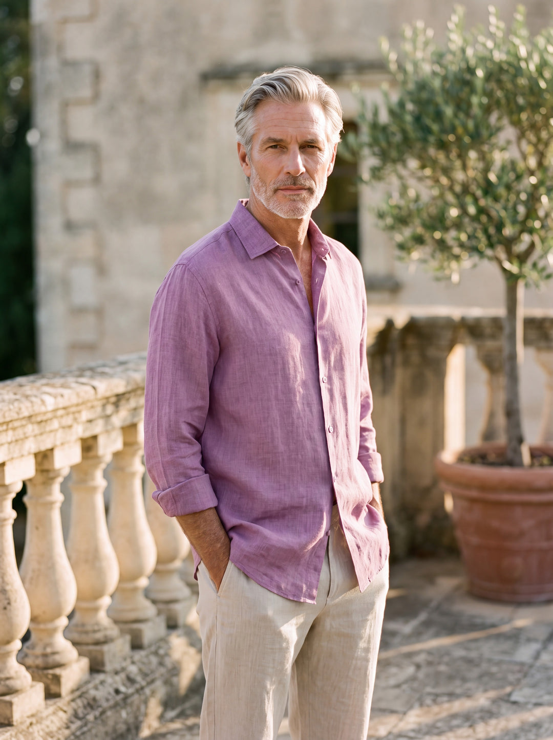 Augustus Men linen shirt in pink, worn by a model on a Mediterranean terrace - Gentlemens Manor lifestyle