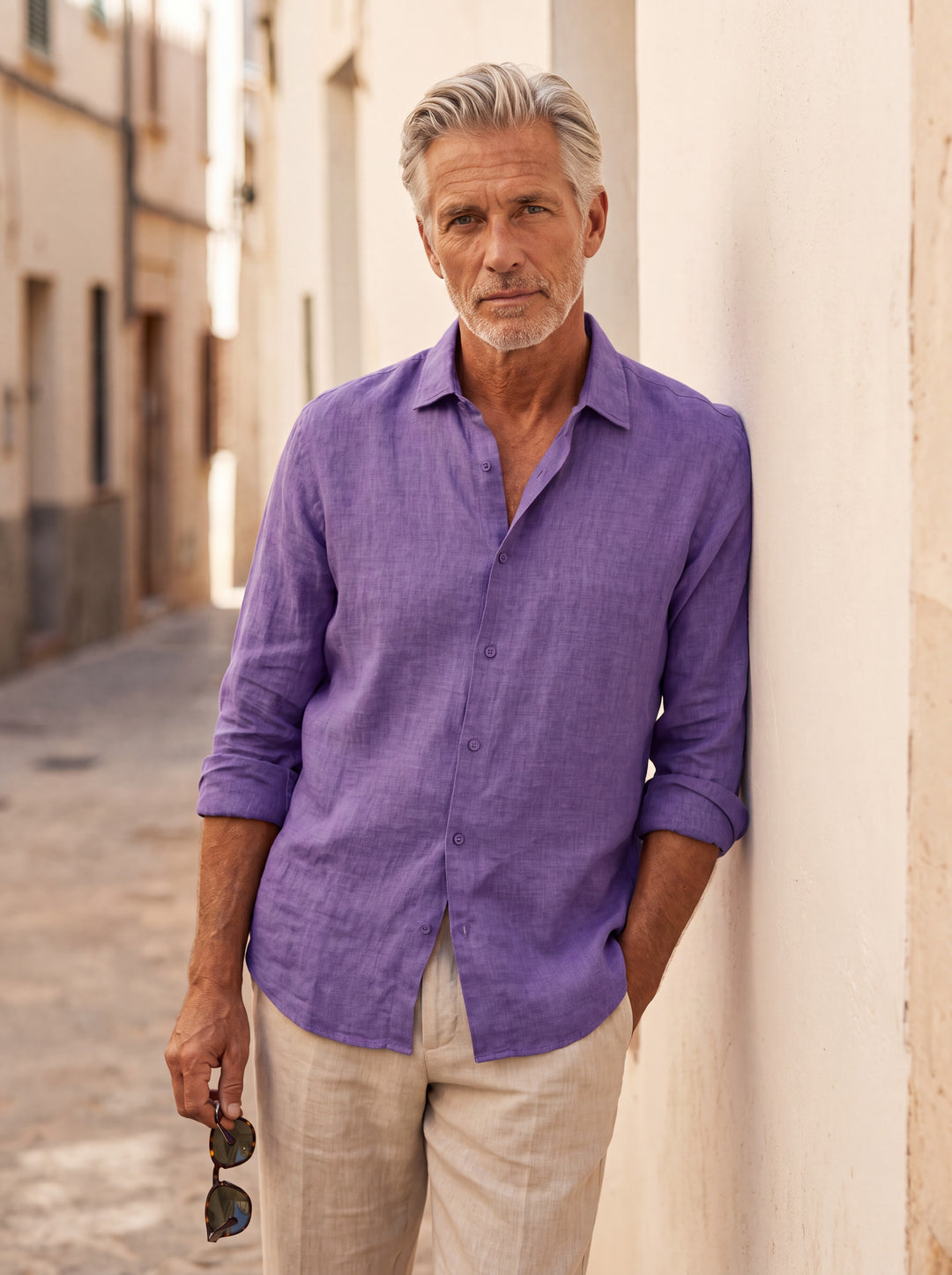 Augustus Men linen shirt in purple, worn by a model on a Mediterranean terrace - Gentlemens Manor lifestyle