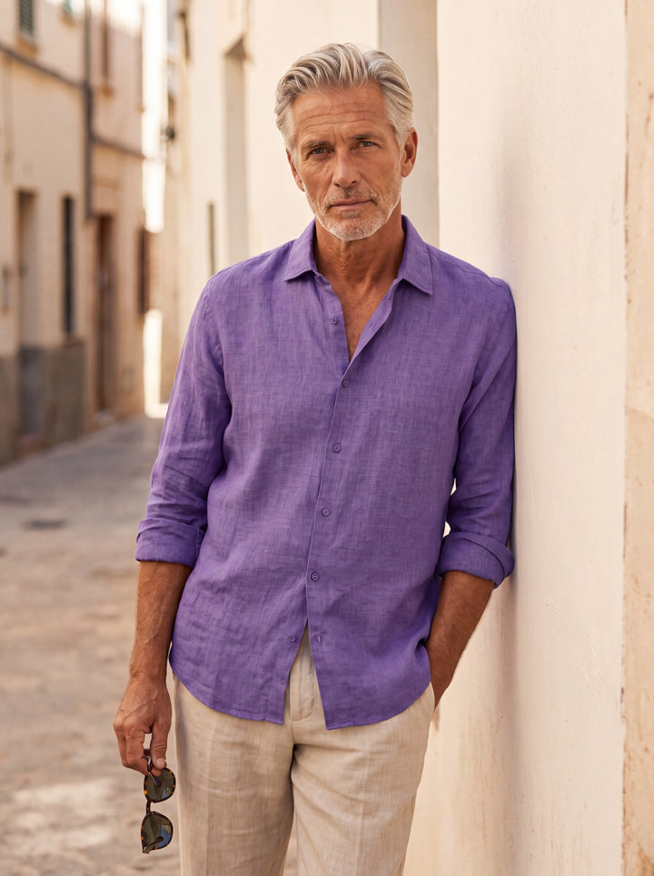 Augustus Men linen shirt in purple, worn by a model on a Mediterranean terrace - Gentlemens Manor lifestyle
