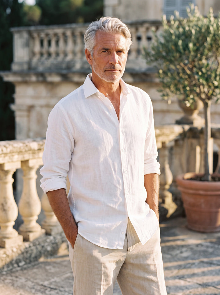 Austin Men linen shirt in white, worn by a model on a Mediterranean terrace - Gentlemens Manor lifestyle