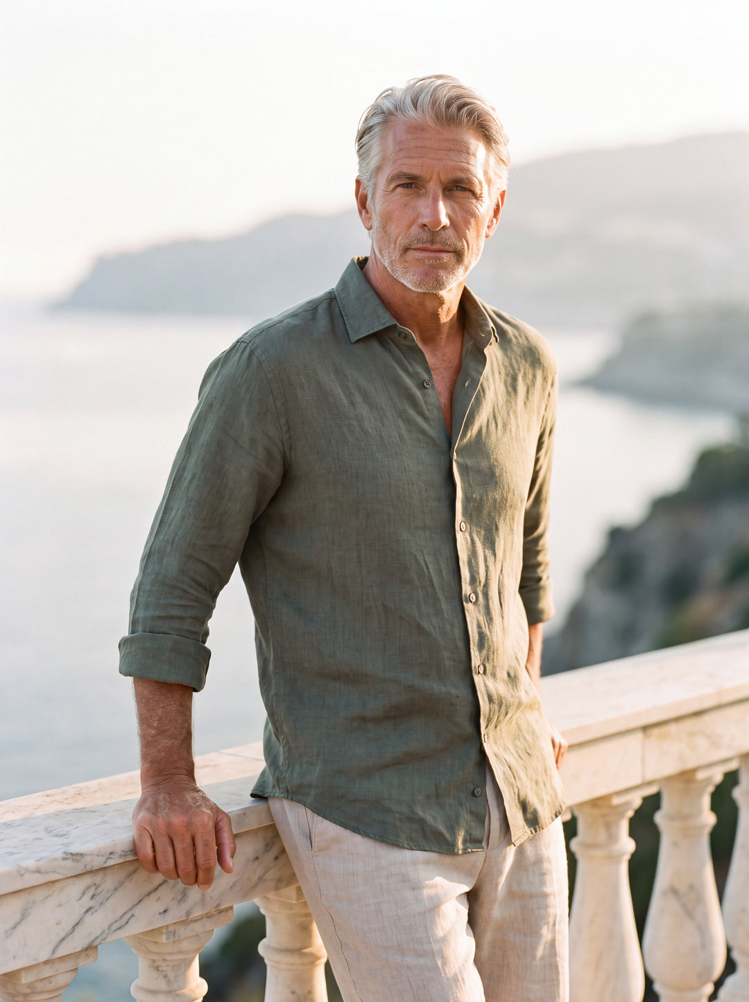 Avery Men linen shirt in Olive, worn by a model on a Mediterranean terrace - Gentlemens Manor lifestyle