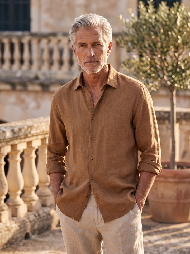 Avery Men linen shirt in Camel, worn by a model on a Mediterranean terrace - Gentlemens Manor lifestyle