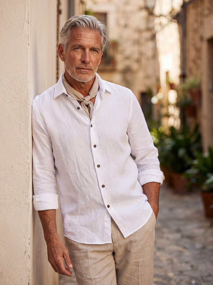Axel Men linen shirt in white, worn by a model on a Mediterranean terrace - Gentlemens Manor lifestyle