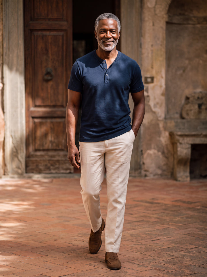 Baldwin Men henley shirt in navy, worn by a model on a Mediterranean terrace - Gentlemens Manor lifestyle