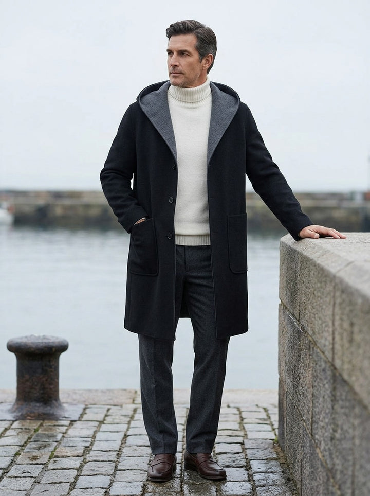 Barlow hooded overcoat in Black, lifestyle on a stone harbor quay, Gentlemens Manor