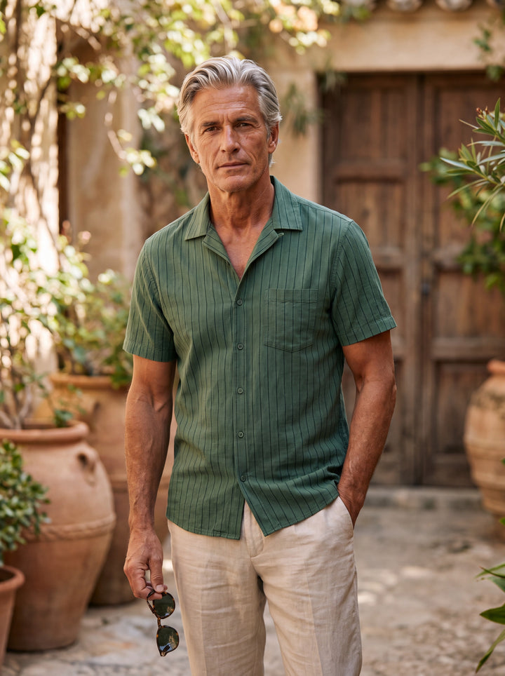 Barnaby Men short sleeve shirt in green, worn by a model on a Mediterranean terrace - Gentlemens Manor lifestyle