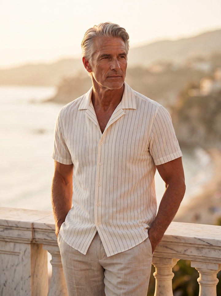 Barnaby Men short sleeve shirt in white, worn by a model on a Mediterranean terrace - Gentlemens Manor lifestyle