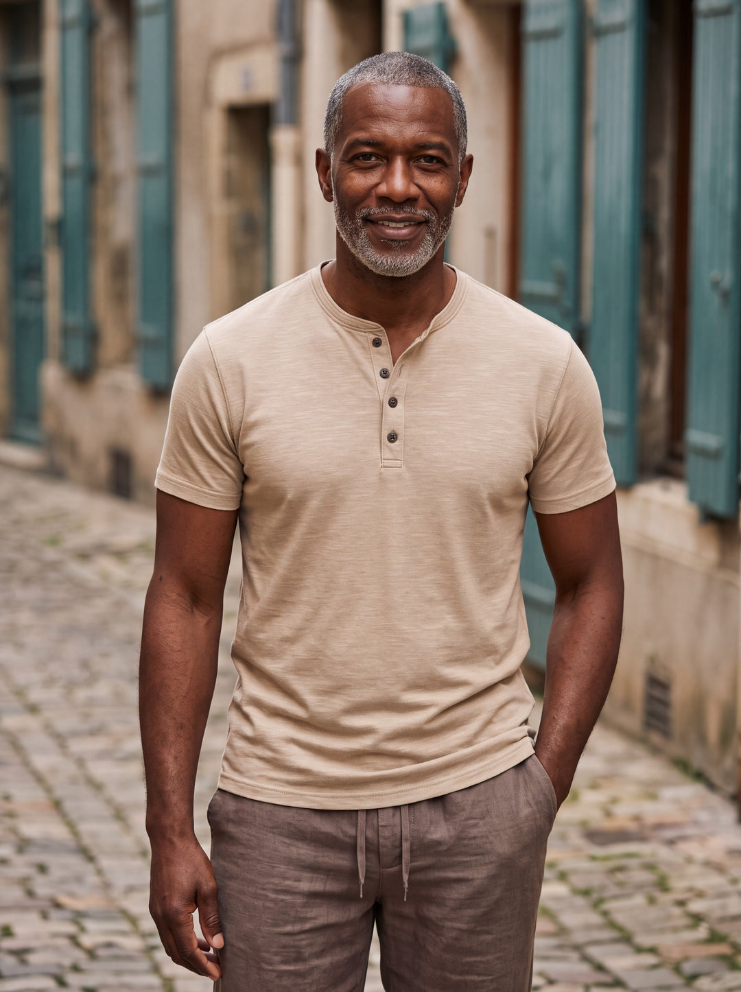 Basil Men polo shirt in sand, worn by a model on a Mediterranean terrace - Gentlemens Manor lifestyle