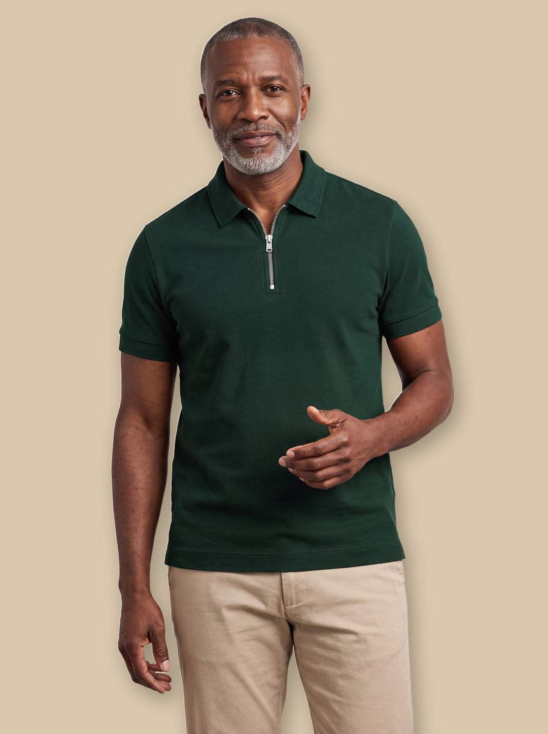 Baxter polo shirt in Green, worn by a model on a warm sand studio background - Gentlemens Manor