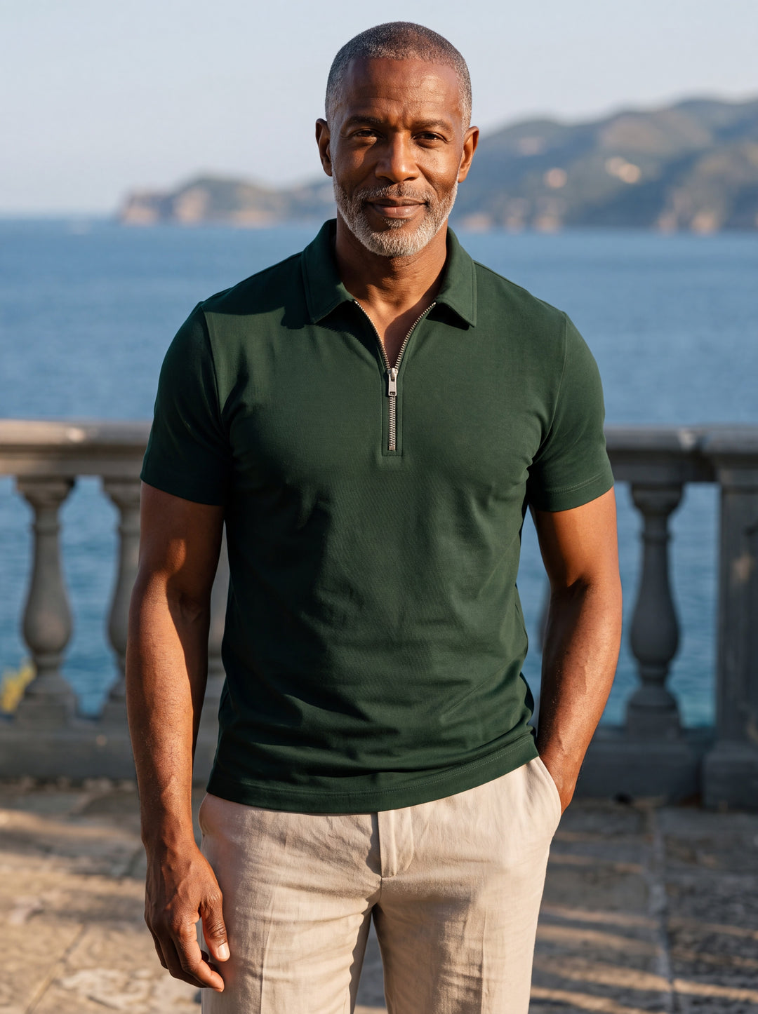Baxter Men polo shirt in green, worn by a model on a Mediterranean terrace - Gentlemens Manor lifestyle