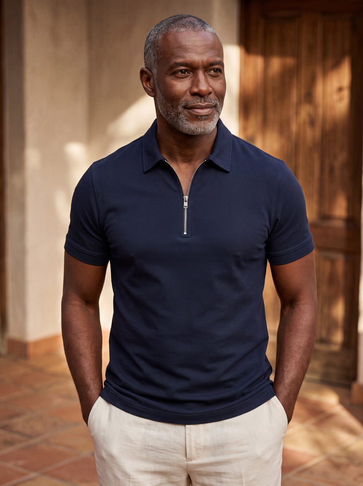 Baxter Men polo shirt in navy, worn by a model on a Mediterranean terrace - Gentlemens Manor lifestyle