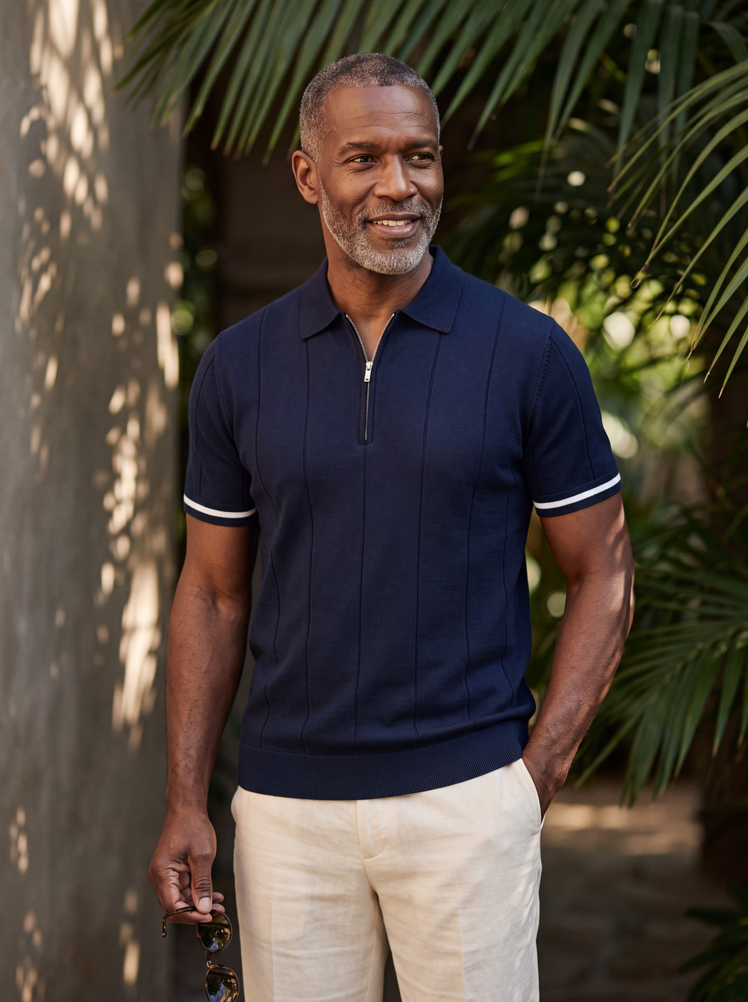 Benjamin Men polo shirt in navy, worn by a model on a Mediterranean terrace - Gentlemens Manor lifestyle