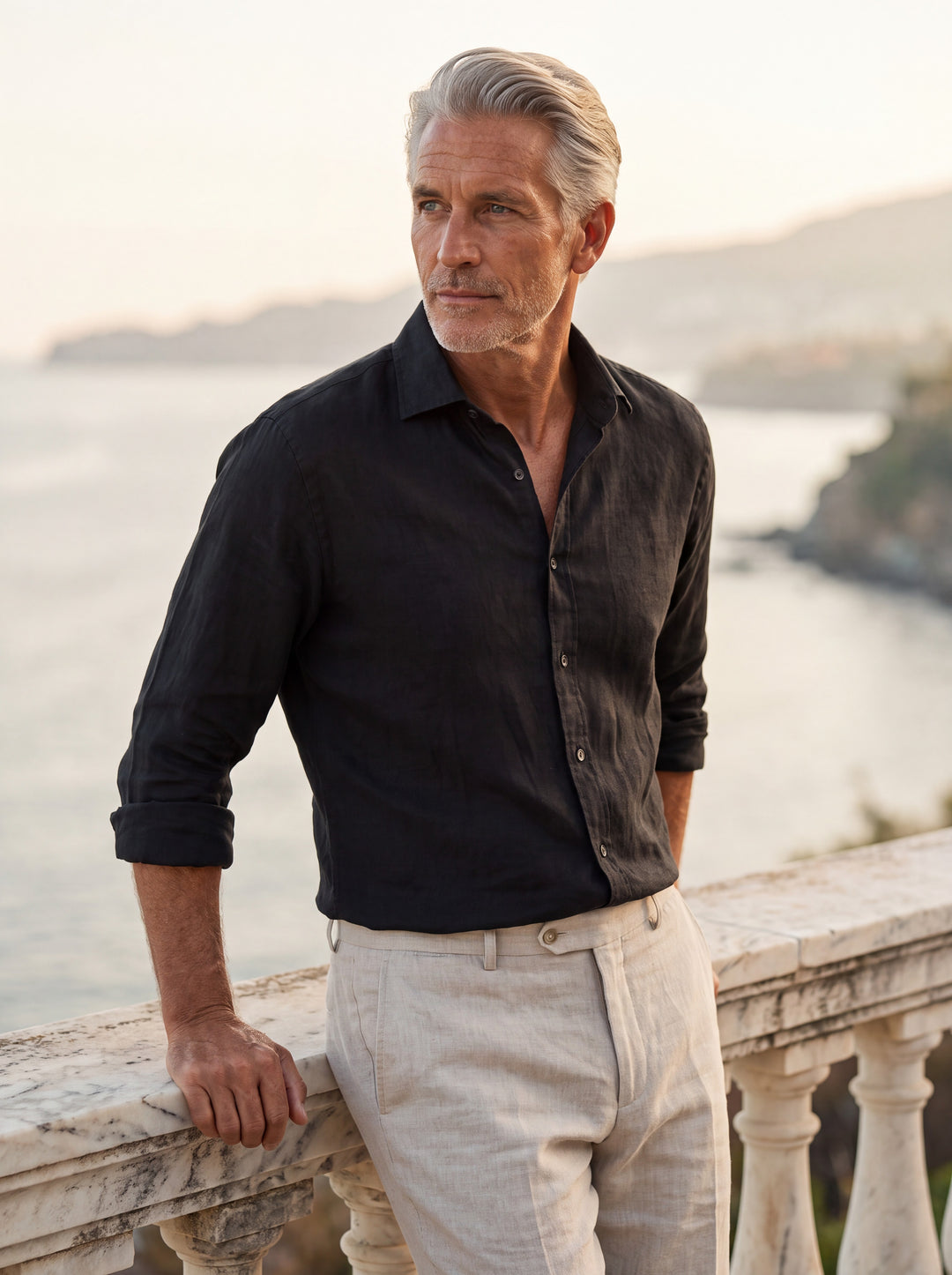 Bennett Men linen shirt in black, worn by a model on a Mediterranean terrace - Gentlemens Manor lifestyle