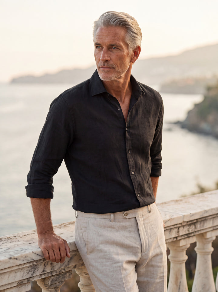 Bennett Men linen shirt in black, worn by a model on a Mediterranean terrace - Gentlemens Manor lifestyle
