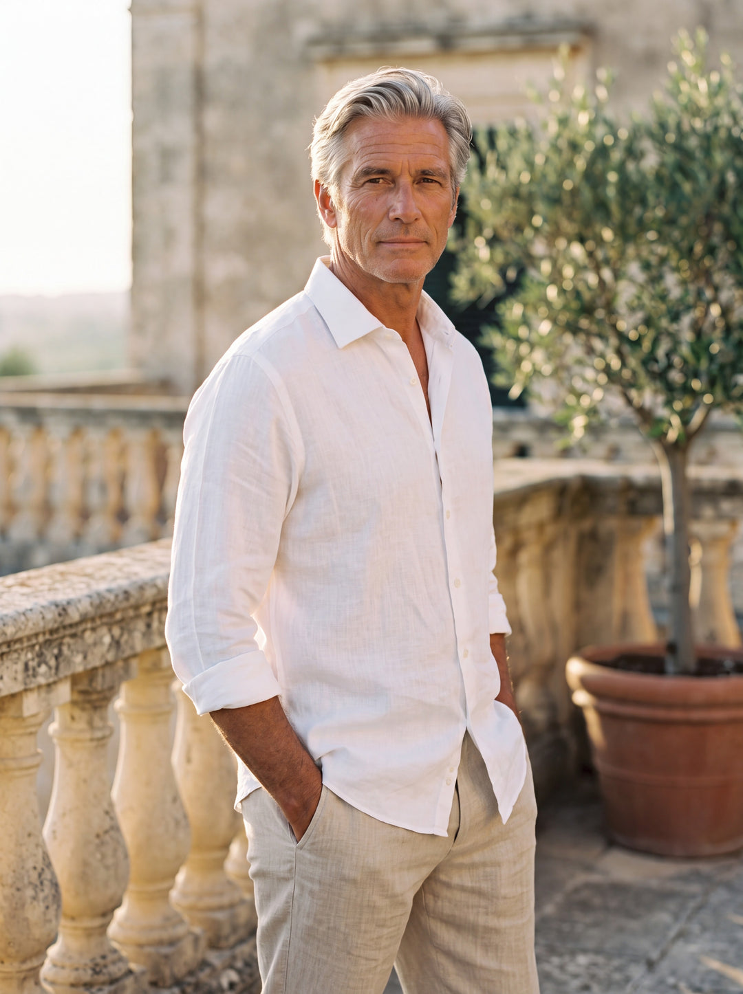 Bennett Men linen shirt in white, worn by a model on a Mediterranean terrace - Gentlemens Manor lifestyle