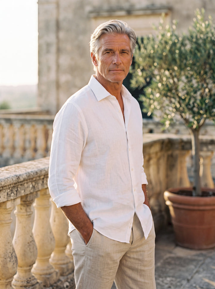 Bennett Men linen shirt in white, worn by a model on a Mediterranean terrace - Gentlemens Manor lifestyle