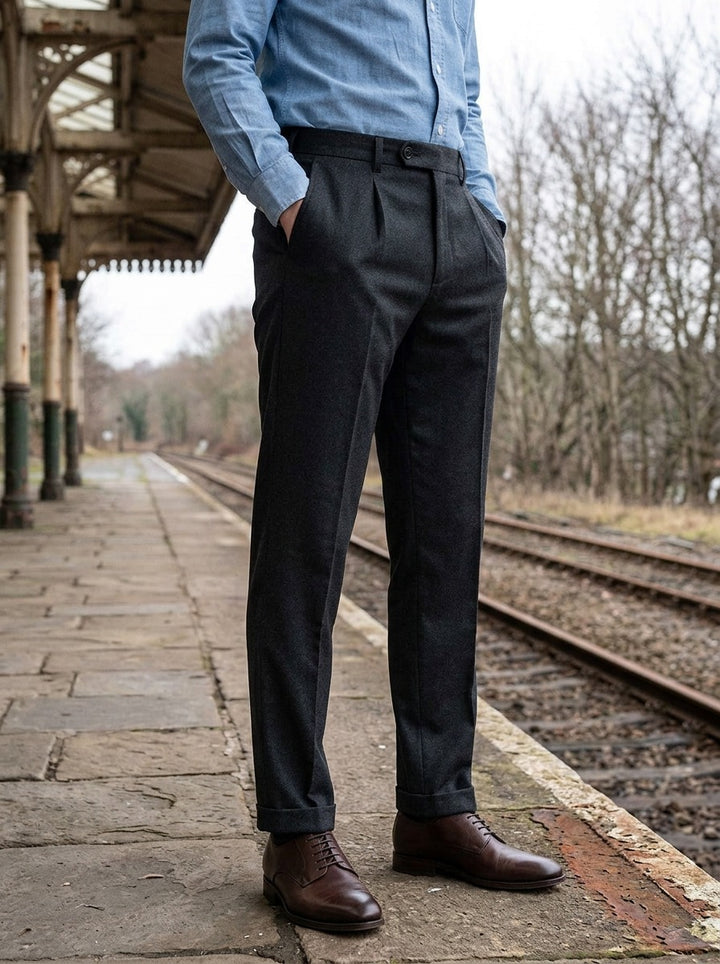 Benton slim tapered pleated trousers in Charcoal, lifestyle on a railway platform, Gentlemens Manor