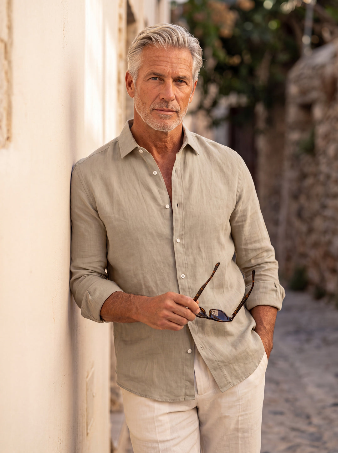 Bernard Men linen shirt in beige, worn by a model on a Mediterranean terrace - Gentlemens Manor lifestyle