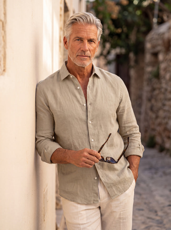 Bernard Men linen shirt in beige, worn by a model on a Mediterranean terrace - Gentlemens Manor lifestyle