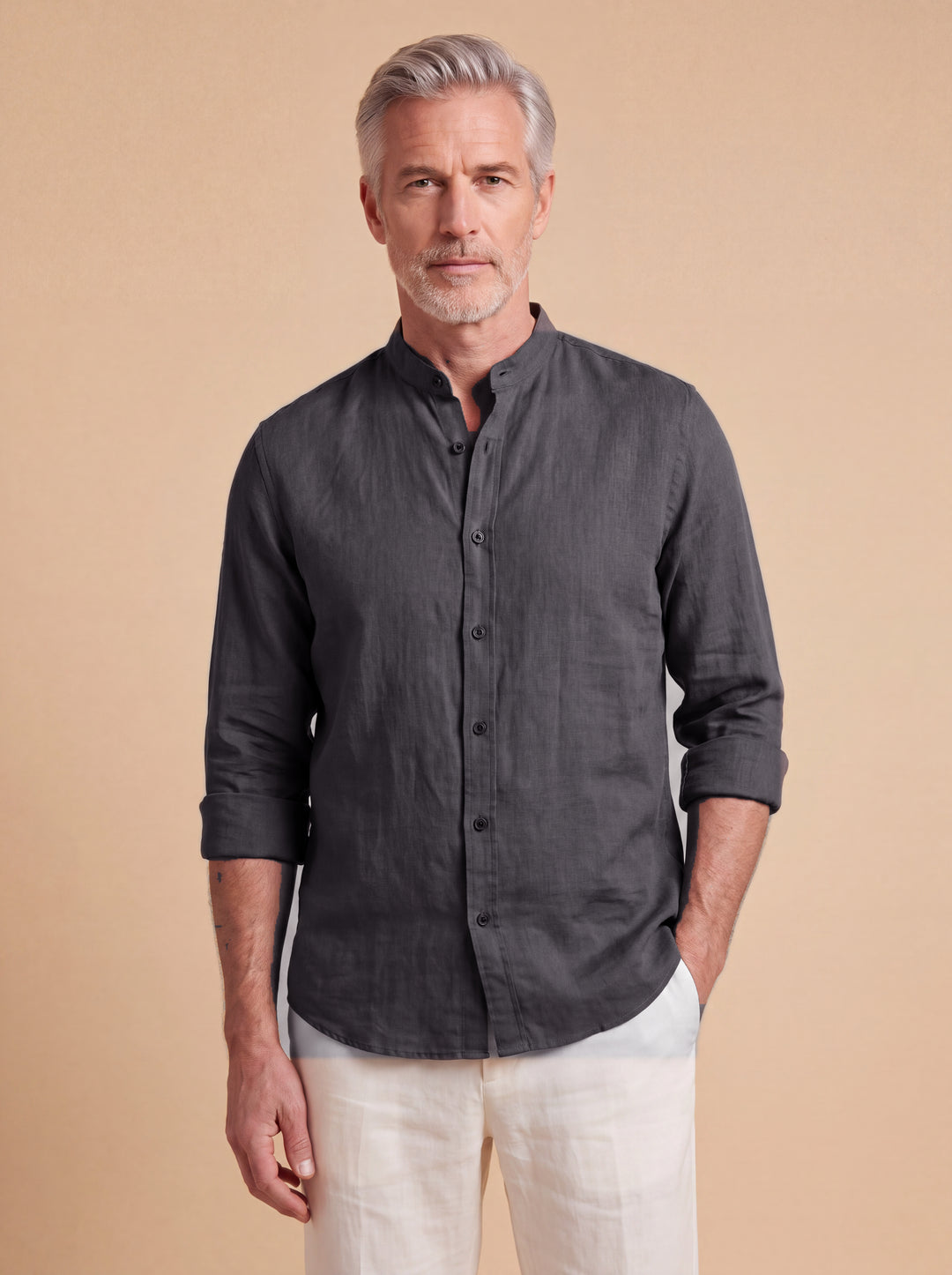 Bernard linen shirt in Charcoal with band collar, worn by a model on a warm sand studio background, Gentlemens Manor