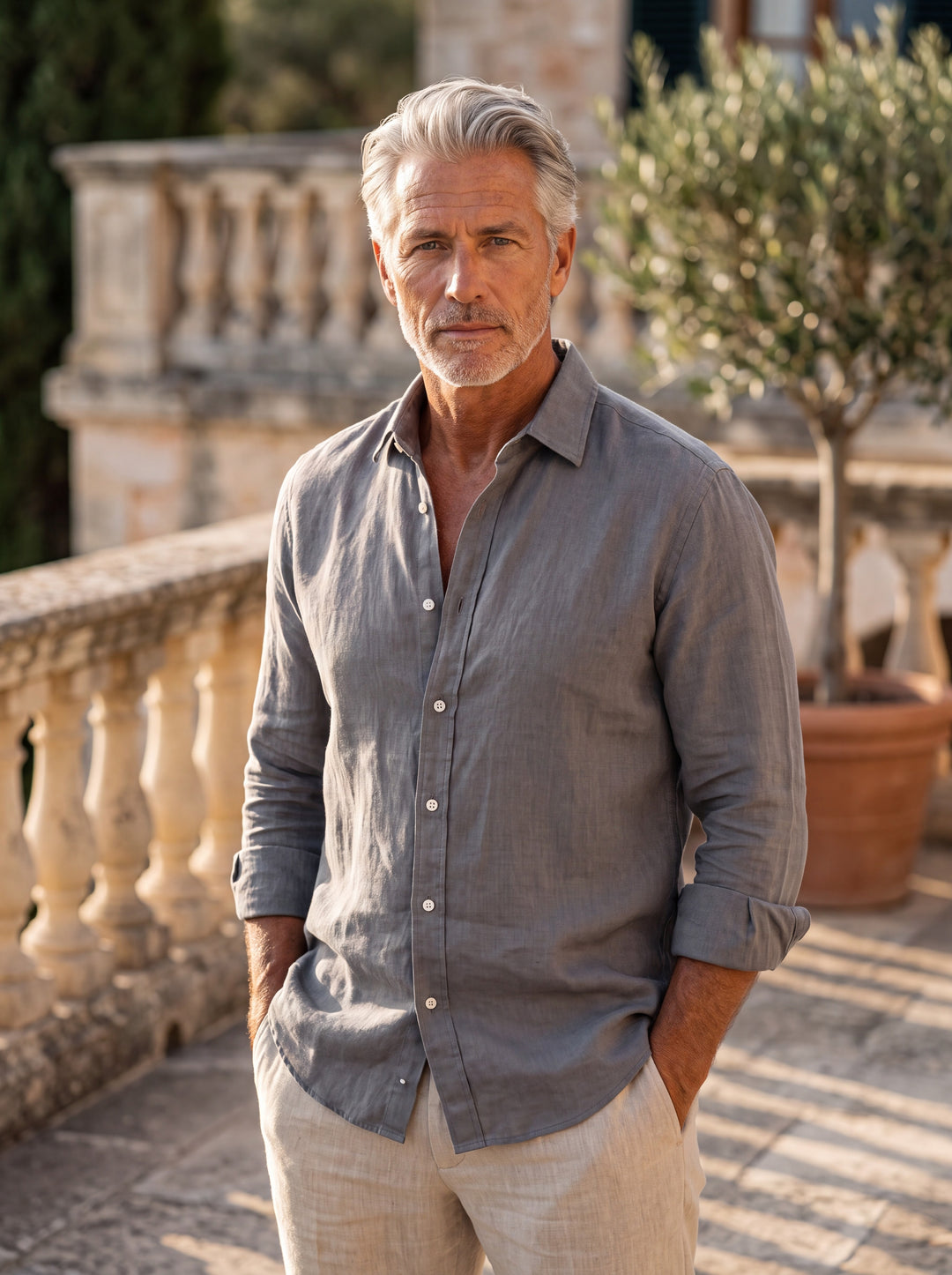 Bernard Men linen shirt in Charcoal, worn by a model on a Mediterranean terrace - Gentlemens Manor lifestyle