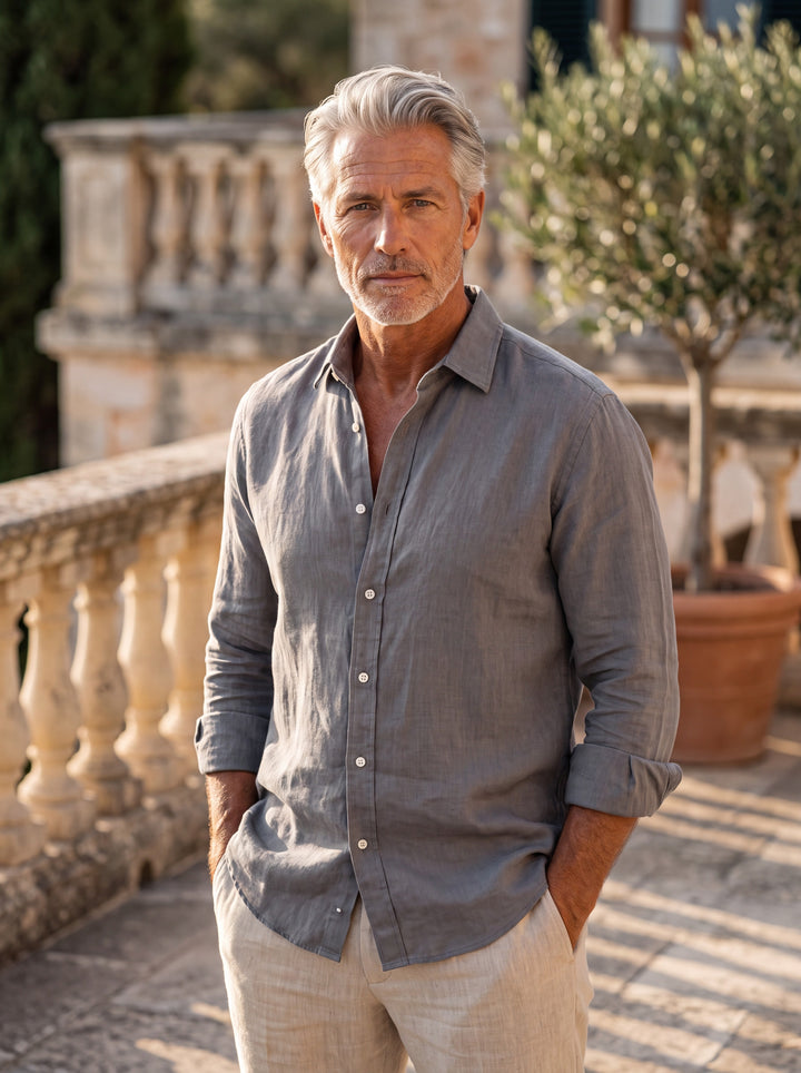 Bernard Men linen shirt in Charcoal, worn by a model on a Mediterranean terrace - Gentlemens Manor lifestyle