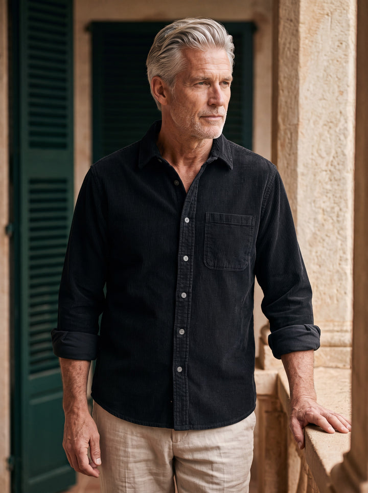 Bishop shirt in Black, worn by a model in a Mediterranean setting - Gentlemens Manor lifestyle