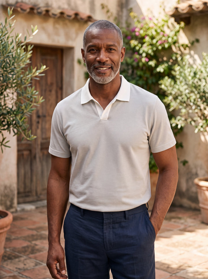 Booker Men polo shirt in grey, worn by a model on a Mediterranean terrace - Gentlemens Manor lifestyle