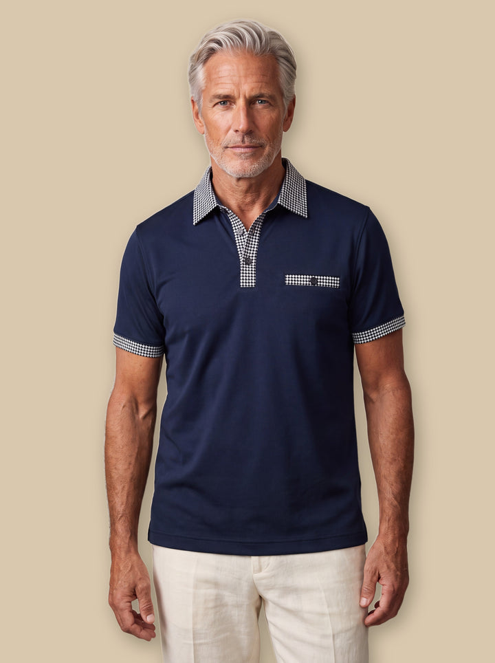 Boone polo shirt in Navy, worn by a model on a warm sand studio background - Gentlemens Manor