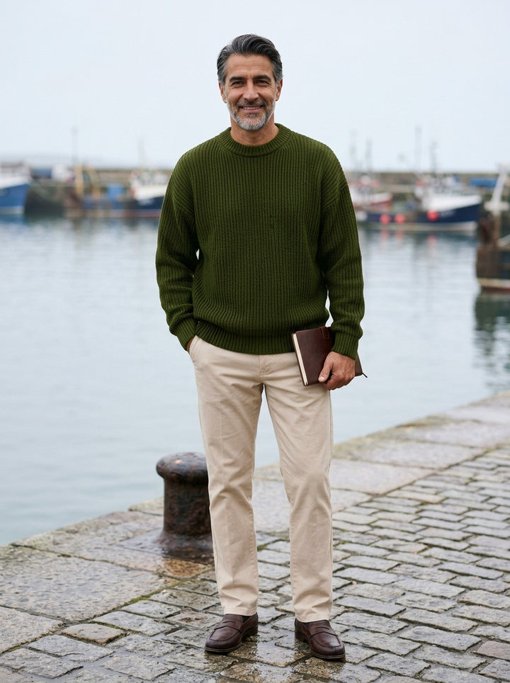 Bowen chunky ribbed crew neck sweater in Olive, lifestyle on a stone harbor quay, Gentlemens Manor