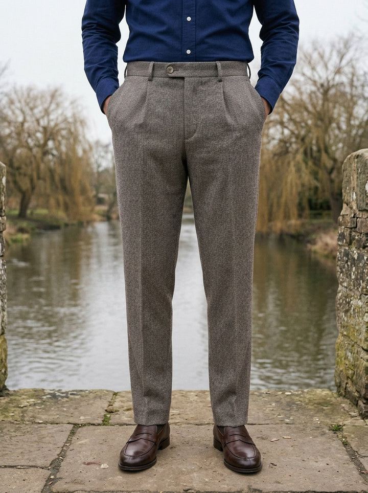 Bowman herringbone single pleat trousers in Brown, lifestyle on a stone footbridge, Gentlemens Manor