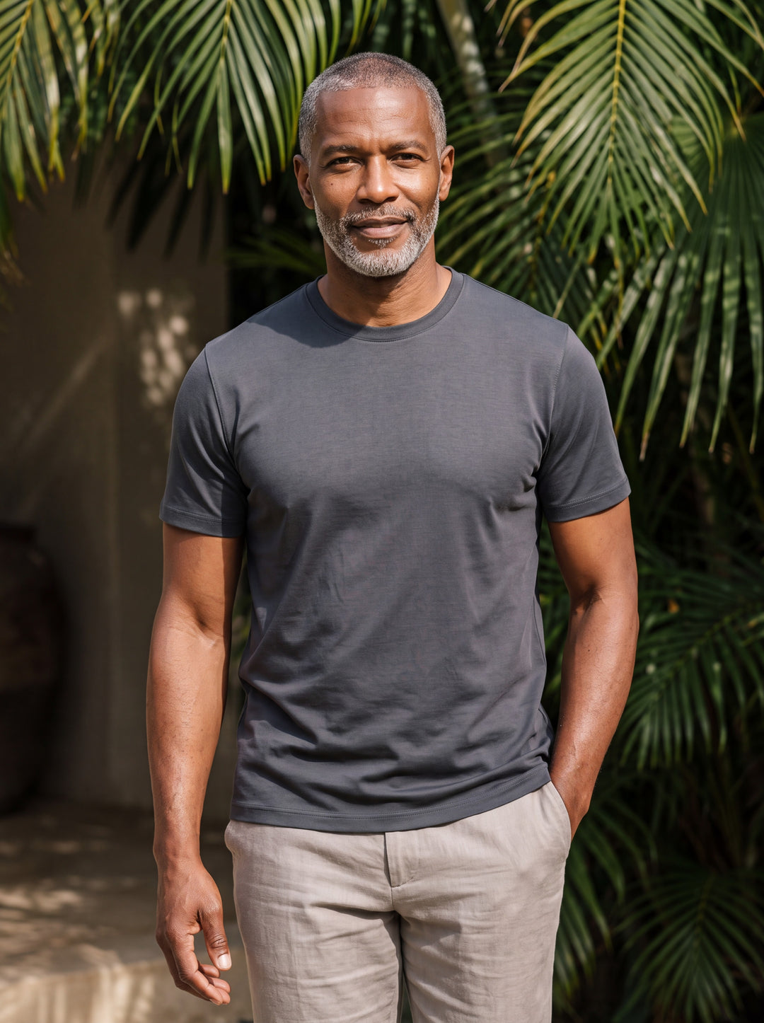 Boyd Men t-shirt in charcoal, worn by a model on a Mediterranean terrace - Gentlemens Manor lifestyle