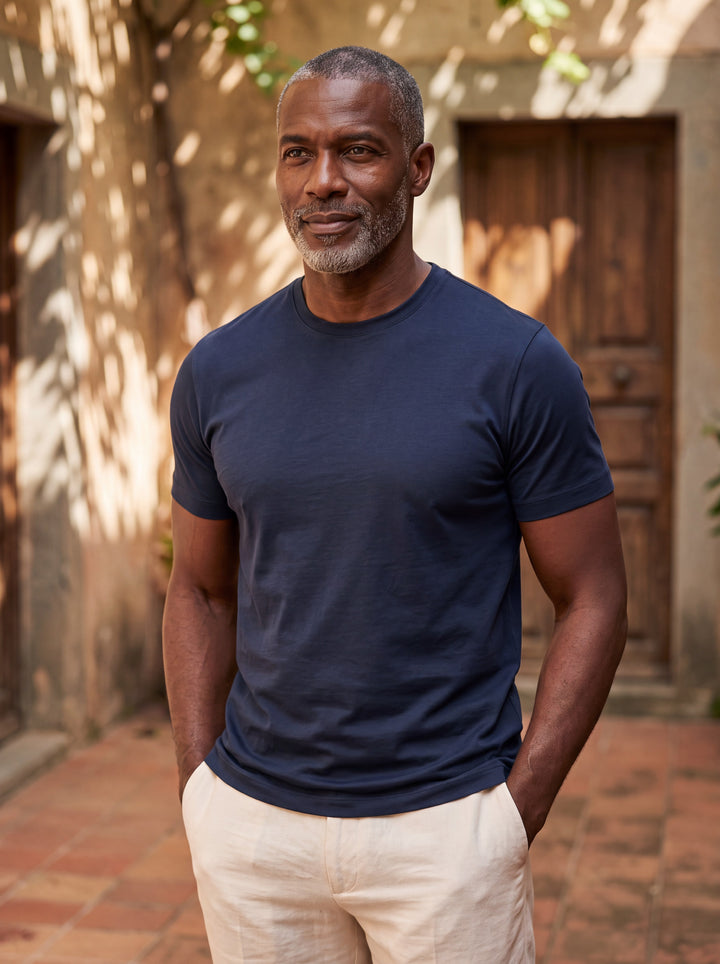 Boyd Men t-shirt in navy, worn by a model on a Mediterranean terrace - Gentlemens Manor lifestyle