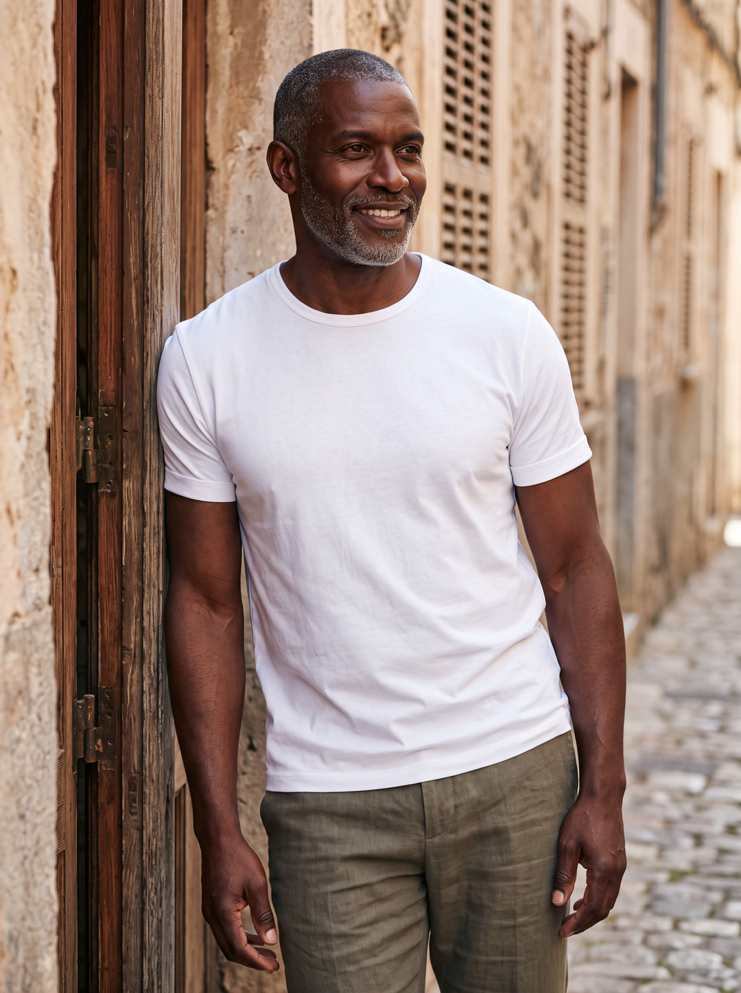 Boyd Men t-shirt in white, worn by a model on a Mediterranean terrace - Gentlemens Manor lifestyle