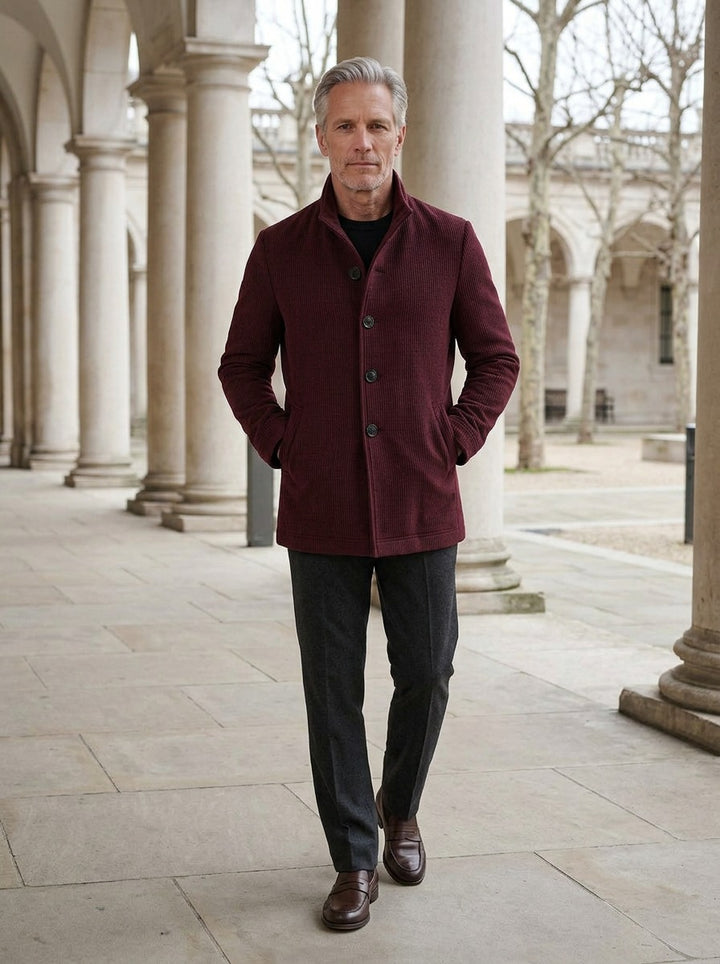 Buckley ribbed stand collar jacket in Burgundy, lifestyle in a stone colonnade, Gentlemens Manor