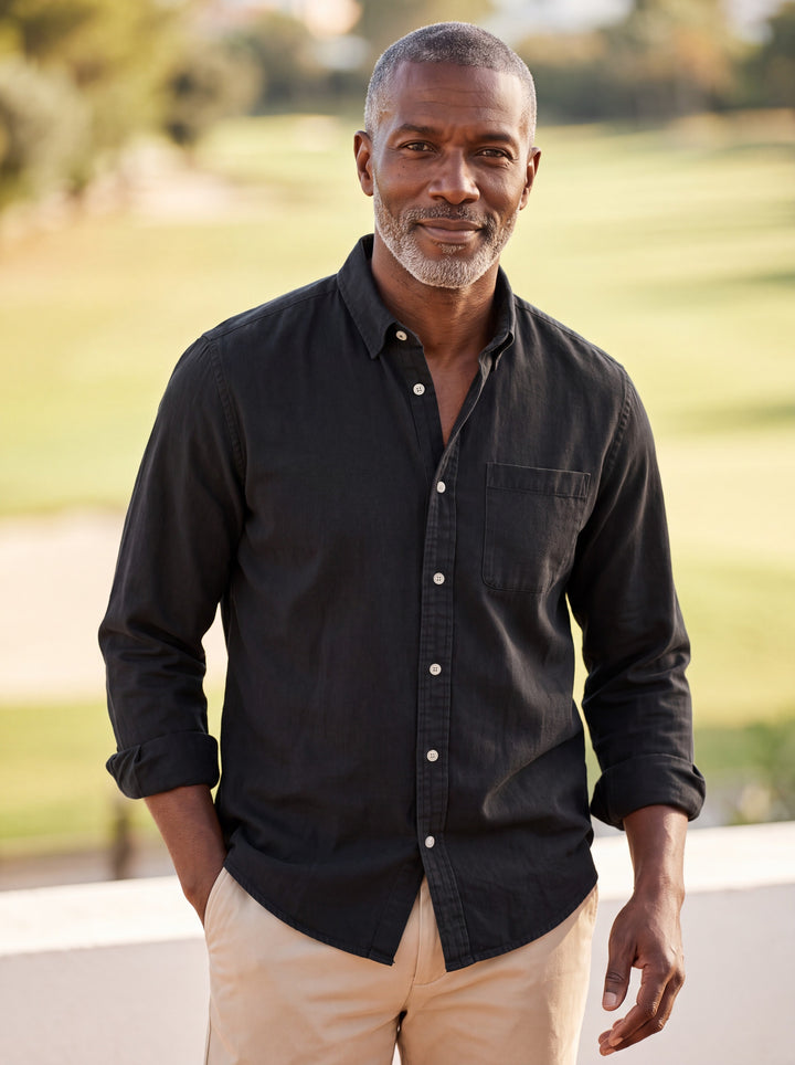 Byron shirt in Black, worn by a model in a Mediterranean setting - Gentlemens Manor lifestyle