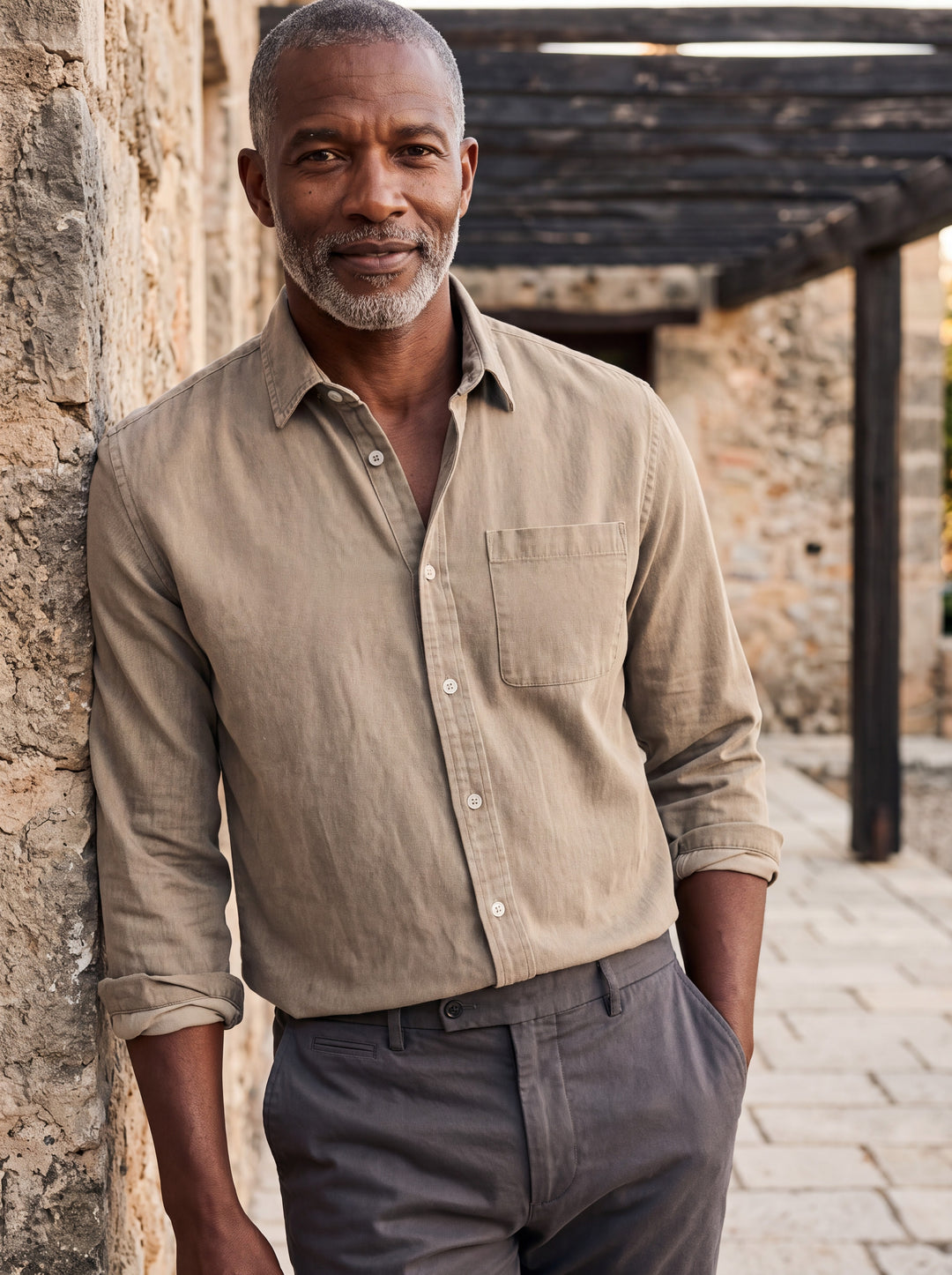 Byron shirt in Sand, worn by a model in a Mediterranean setting - Gentlemens Manor lifestyle